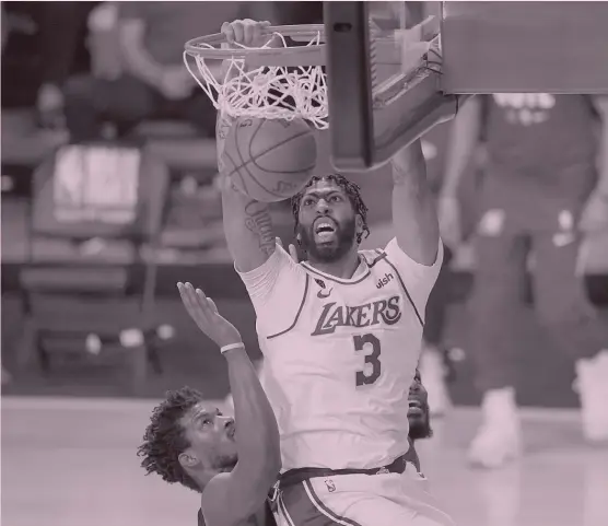 ?? MARK J. TERRILL/ AP ?? Lakers big man Anthony Davis, dunking against Heat star Jimmy Butler, averaged 25 points and 10.7 rebounds in the NBA Finals. The Lakers beat the Heat in six games.