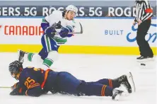  ?? PERRY NELSON/USA TODAY SPORTS ?? Oilers defencemen Darnell Nurse tries to block a shot by Canucks counterpar­t Quinn Hughes on Thursday.