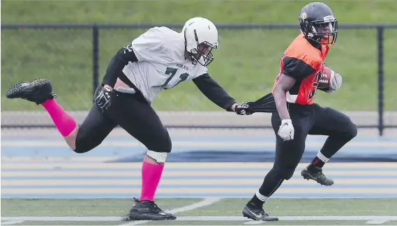  ?? PHOTOS: DAN JANISSE ?? Craig Barr, left, of the Belle River Nobles chases Ahl Djinko of L’Essor during their WECSSAA AA title tilt Thursday at the University of Windsor Alumni Field.