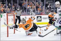  ?? [MATT SLOCUM/THE ASSOCIATED PRESS] ?? The Flyers’ Carter Hart blocks a shot by the Vancouver Canucks’ Nikolay Goldobin (77) during the third period Monday in Philadelph­ia. Philadelph­ia won 2-1.