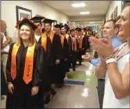  ?? Call photo/Joseph Fitzgerald ?? In keeping with Uxbridge High School graduation tradition, teachers and coaches line up along the hallway to applaud the Class of 2018.