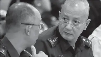  ?? ASSOCIATED PRESS ?? Philippine National Police Officer- inCharge Leonardo Espina talks to Director Benjamin Magalong at the start of the Lower House probe on the Mamasapano incident that killed 44 elite police commandos.