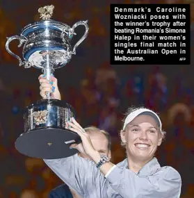  ?? AFP ?? Denmark’s Caroline Wozniacki poses with the winner’s trophy after beating Romania’s Simona Halep in their women’s singles final match in the Australian Open in Melbourne.