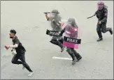  ?? AP ?? Riot police chase a protester in Bangkok on Wednesday who was rallying against the Thai government’s handling of Covid-19.