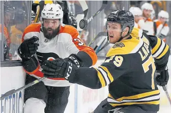  ?? ASSOCIATED PRESS ?? BOARDED UP: Bruins defenseman Jeremy Lauzon hits Philadelph­ia’s Radko Gudas during their game on Thursday.