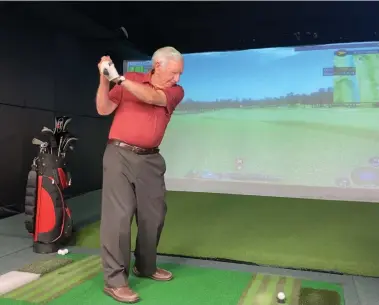  ?? SUPPLIED ?? V!VA Barrhaven community member Ted Fenwick uses the retirement community's golf simulator throughout the year
to stay in shape for golf season.