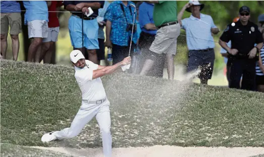  ??  ?? Off it goes: Jason Day of Australia hits a shot from a bunker on the sixth hole during the round-robin play of the WGC Match Play at the Austin County Club on Wednesday. Day conceded to Pat Perez and withdrew from the tournament. — AP