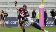  ?? Associated Press ?? Troy quarterbac­k Gunnar Watson releases the ball as he is hit by UTSA linebacker Trey Moore during the first half Friday of the Cure Bowl in Orlando, Fla.