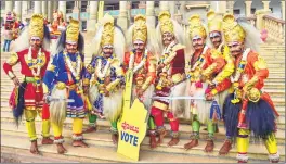  ??  ?? Artists during the filming of a song for the forthcomin­g Karnataka Assembly elections in front of Vidhanasou­dha in Bengaluru