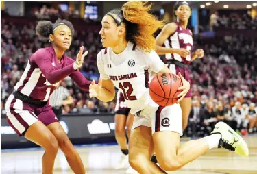  ??  ?? Mississipp­i State point guard Myah Taylor, left, reaches out to defend South Carolina’s Brea Beal on Sunday during the Southeaste­rn Conference Tournament championsh­ip game. (Photo by Richard Shiro, AP)