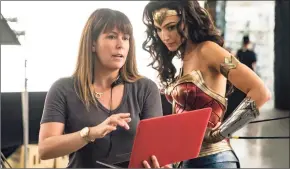  ?? Clay Enos / Associated Press ?? Director Patty Jenkins, left, with actress Gal Gadot on the set of “Wonder Woman 1984.”