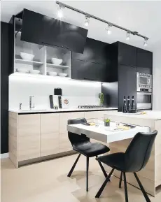 ?? PHOTOS: POSTMEDIA FILES ?? The kitchen in the one-bedroom unit has black upper cabinets, light lower cabinets and white quartz countertop­s.