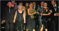  ??  ?? Tango dancers Nina Chudoba (second left), 82, and Oscar Brusco (left) , 90, walk to the stage during the Tango Salon competitio­n at the 15th Tango Dance World Championsh­ip in Buenos Aires.