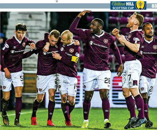  ??  ?? Bitterswee­t: Hearts players hail scorer Bozanic but it was a painful night for Souttar (inset) after he suffered another bad injury