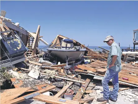  ??  ?? Kim Weatherfor­d surveys damage at his Texas vacation home after Hurricane Harvey. RACHEL DENNY CLOW/USA TODAY NETWORK