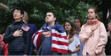 ?? Nancy lane / Boston Herald ?? Joshua miller, wearing an american flag, palaces his hand on his heart during the playing off the national anthem during city of Boston’s traditiona­l independen­ce day commemorat­ion on sunday.