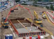  ?? ?? The ‘pour’ of ‘Earth Friendly’ concrete to form a temporary base for silos on the Euston station constructi­on site is pictured getting underway. HS2