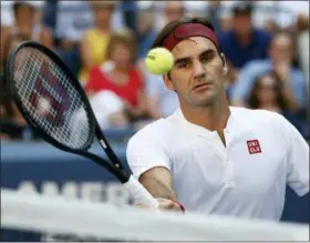  ?? JASON DECROW — THE ASSOCIATED PRESS ?? Roger Federer, of Switzerlan­d, returns a shot to Nick Kyrgios, of Australia, during the third round of the U.S. Open tennis tournament, Saturday in New York.