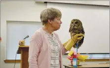  ?? Rachel Dickerson/The Weekly Vista ?? Lynn Sciumbato of Morning Star Wildlife Rehabilita­tion Center in Gravette shows the Bella Vista Garden Club a barred owl named Sydney during a presentati­on about raptors at a meeting of the club on Wednesday, April 26.