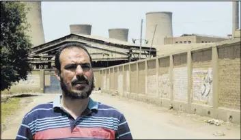  ?? BRIAN ROHAN/THE ASSOCIATED PRESS ?? Kamal al-Fayoumi stands May 10 in front of Misr Spinning and Weaving Company in Mahalla el-Kobra, Egypt. Al-Fayoumi, a labor activist, was fired from the company after nearly three decades of work.