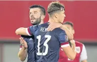  ??  ?? It’s a Viennese waltz for Grant Hanley and Jack Hendry