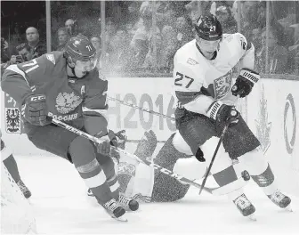  ?? CHRIS YOUNG, THE CANADIAN PRESS ?? Russia’s Evgeni Malkin, left, and Finland’s Joonas Donskoi battle for the puck during first-period action in Toronto on Thursday.