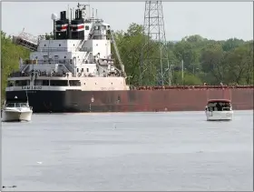  ?? NEWS-HERALD FILE ?? Two smaller powerboats share the Grand River in Fairport Harbor with a freighter in 2018. The U.S. Army Corps of Engineers Work Plan for fiscal year 2021 includes $1.42 million in funding to dredge the Fairport Harbor federal navigation channel, which includes sections of Lake Erie and the Grand River.