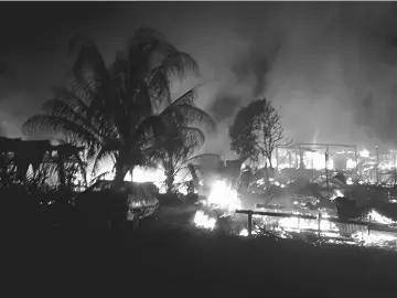  ??  ?? The squatter houses at Kampung Muhibbah in Kuala Baram being consumed by the fire leaving 70 people homeless.