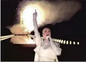  ?? Biden Inaugural Committee via Getty Images ?? KATY PERRY caps “Celebratin­g America” show as fireworks go off behind her in Washington, D.C.