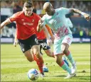  ??  ?? TUSSLE: Luton’s Matty Pearson, left, and Swansea’s Andre Ayew