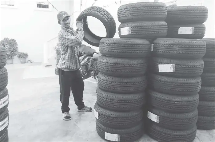  ??  ?? Joel Harrihar in his tyre shop