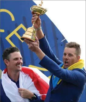  ?? ?? Henrik Stenson celebrates winning the Ryder Cup with Justin Rose