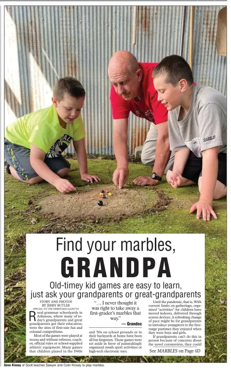  ??  ?? Gene Kinsey of Scott teaches Sawyer and Colin Kinsey to play marbles.
