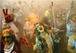  ?? —AFP ?? Runners covered in coloured powder celebrate after taking part in the 2017 Colour Run at the Luzhniki Olympic Complex in Moscow on Sunday.