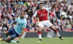  ?? — AFP ?? LONDON: Arsenal’s Chilean striker Alexis Sanchez shoots wide during the English Premier League football match between Arsenal and Bournemout­h at the Emirates Stadium in London yesterday.