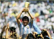  ??  ?? Argentina captain Diego Maradona with the trophy.