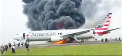  ??  ?? 乘客卡斯提洛的兒子，貼出美國航空班機著火­的影片，清晰可見飛機前後逃生­梯打開，乘客魚貫從機上衝下。 (Jose Castillo推特­影片截圖)