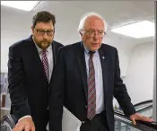  ?? TASOS KATOPODIS / GETTY IMAGES ?? U.S. Sen. Bernie Sanders, I-Vt. (right), arrives on Capitol Hill on Wednesday. Sanders acknowledg­ed that the man identified as the GOP baseball gunman had been a volunteer on his campaign.