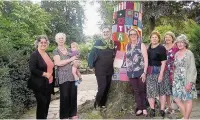  ??  ?? Members of the Heatons WI with Ann Coffey MP and the work the ‘yarnstormi­ng’ group has created in Heaton Moor Park