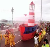  ??  ?? Activists of the Extinction Rebellion Movement wheel a red and white lightship along the seafront as they sound the alarm about climate change during the Labour party conference in Brighton, England, on Sunday.