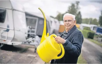  ?? RP-FOTO: RALPH MATZERATH, ?? Wolfgang aus Aachen geht Wasser holen, damit der Tank in seinem Wohnwagen gefüllt ist und es dort fließendes Wasser gibt.