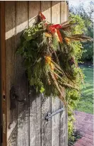  ??  ?? BELOW LEFT Pheasant feathers add a dramatic flourish to the wreath. RIGHT A glazed door leads to the conservato­ry, where a bright floral rug from Armenia takes centre stage.
