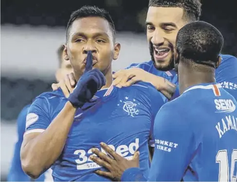  ??  ?? 0 Alfredo Morelos celebrates after ending his recent goal drought as Rangers beat St Mirren 2-0 in Paisley to stay 16 points clear.