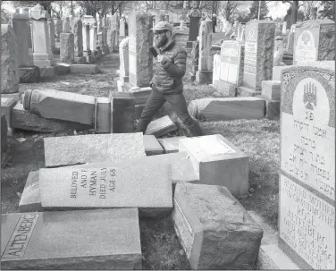  ?? Jacqueline Larma/AP ?? Cemetery: Rabbi Joshua Bolton of the University of Pennsylvan­ia's Hillel center surveys damaged headstones at Mount Carmel Cemetery in Philadelph­ia. The shooting rampage that killed more than 10 people at Pittsburgh's Tree of Life Synagogue on Saturday, is being decried as the deadliest attack on Jews in U.S. history. Yet the carnage, however unpreceden­ted, is not an aberration: Year after year, decade after decade, anti-Semitism proves to be among the most entrenched and pervasive forms of hatred and bigotry in the United States.