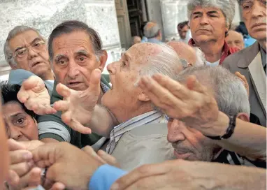  ??  ?? HARSH REALITY: Pensioners try to get a number to enter a bank in Athens yesterday. About 1 000 branches around the country were ordered by the government to reopen yesterday to help desperate pensioners, without ATM cards, cash up to 120 from their...