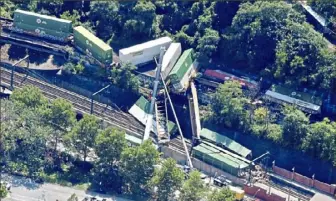  ?? Darrell Sapp/Post-Gazette ?? A view during cleanup of the derailment of the Norfolk Southern train above the Station Square LRT Station and over East Carson Street on Aug. 6 on the South Side.