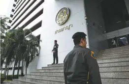  ??  ?? Policemen stand guard outside the criminal court in Bangkok yesterday.