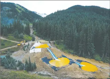  ?? AP/BRENNAN LINSLEY ?? Water flows Aug. 12 through a series of retention ponds built to contain and filter out heavy metals and chemicals from the Gold King mine chemical accident in the spillway about one-quarter of a mile downstream from the mine outside Silverton, Colo.