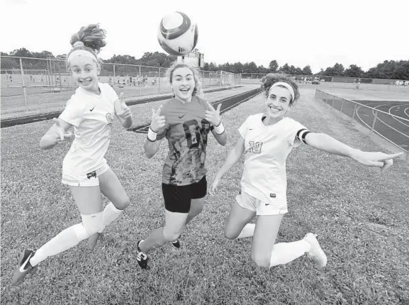  ?? KENNETH K. LAM/BALTIMORE SUN ?? From left, Wilde Lake's Julianna Bonner, Jenna Hutchison and Lily Dunbar, who have played togethr since youth soccer, have led the Wildecats to a 9-0-1 record and No. 6 ranking.