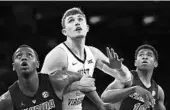  ?? SARAH STIER/GETTY ?? West Virginia’s Logan Routt tangles with Florida’s Keith Stone (left) and Noah Locke for a rebound in the Gators’ 66-56 victory Tuesday night in Madison Square Garden.